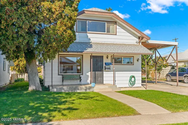 a front view of a house with a yard