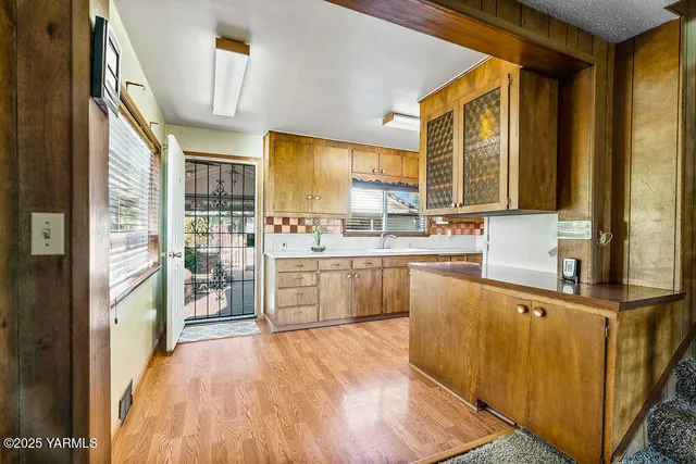 a kitchen with stainless steel appliances a sink and a refrigerator