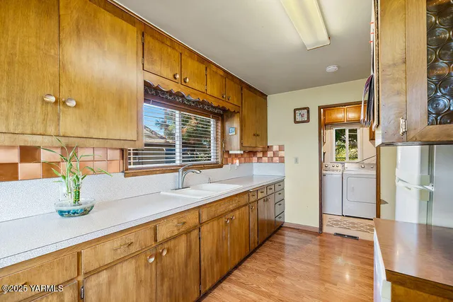 a hallway with sink and mirror