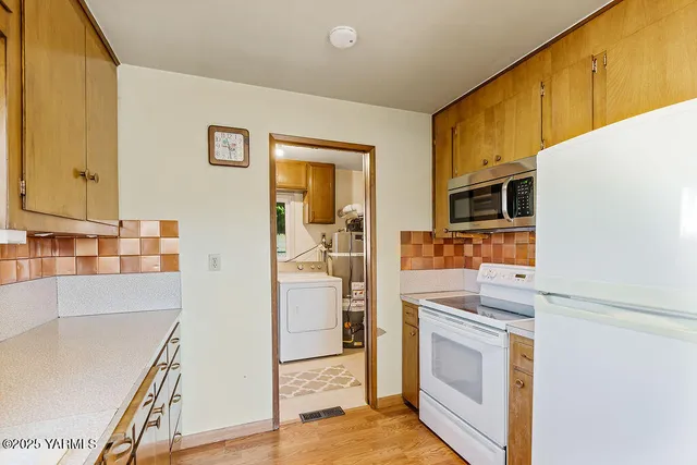 a kitchen with stainless steel appliances a refrigerator and a stove top oven
