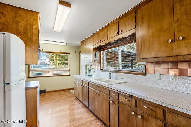 a large bathroom with a large window and double vanity