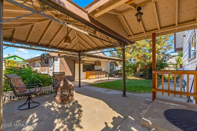 a view of a porch with furniture and a yard