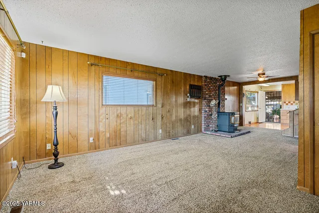 a view of a livingroom with wooden floor and a bathroom