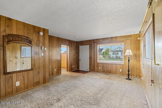 an empty room with windows and closet