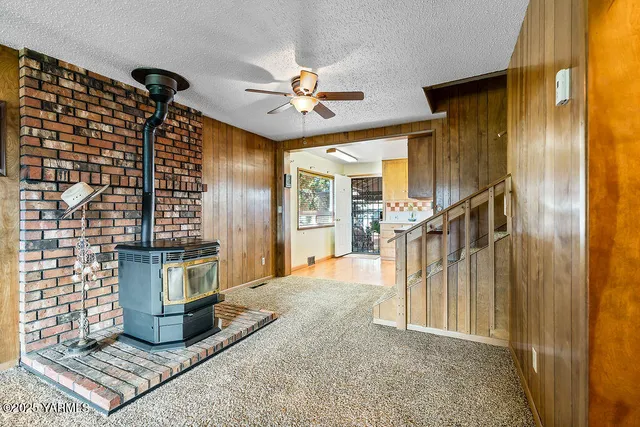 a view of a livingroom with wooden floor and stairs