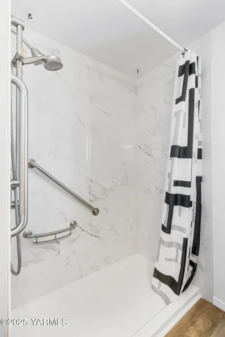 a bathroom with a shower and a tub