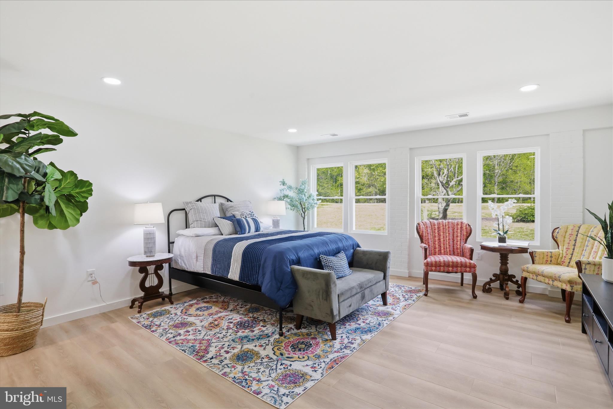 2502 Holly Springs Road Amissville, VA 20106 - Photo 24 of 52 a spacious bedroom with a bed a table and a potted plant