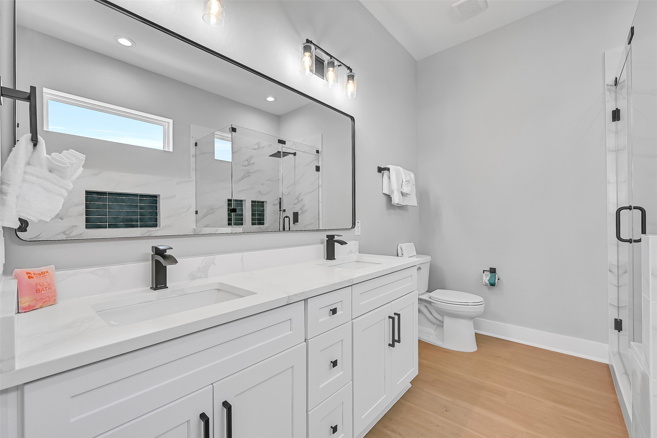 16728 West Beach Road Jamaica Beach, TX 77554 - Photo 27 of 46 This bathroom features double sinks, abundant cabinetry, quartz countertops, a spacious walk-in shower, and a separate soaking tub.
