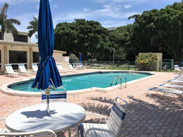 a park view with a bench in the patio