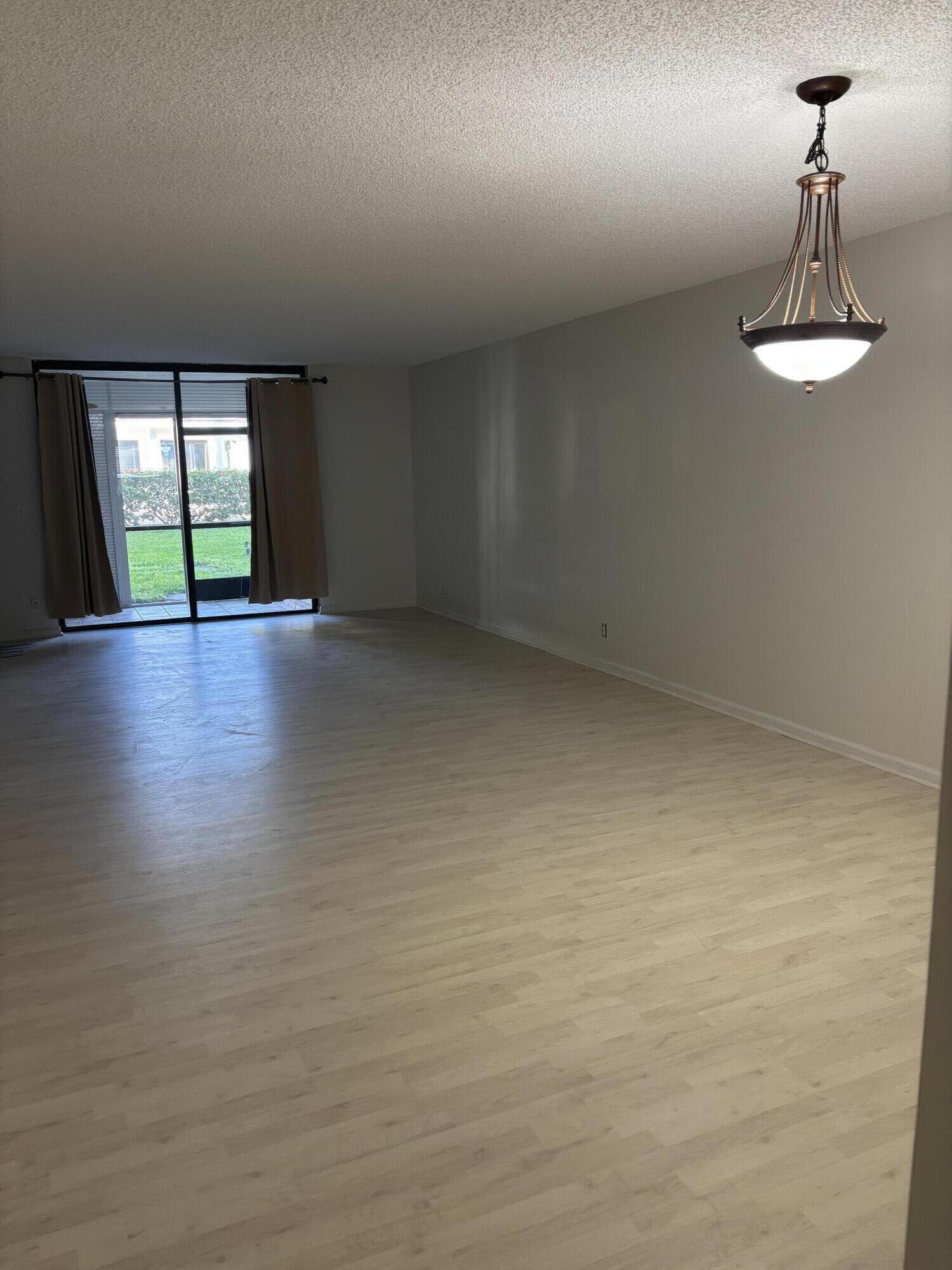555 Banyan Tree Lane, Unit 109 Delray Beach, FL 33483 - Photo 15 of 17 a view of room with window and hardwood floor