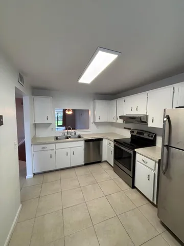 a kitchen with a white cabinets and white appliances