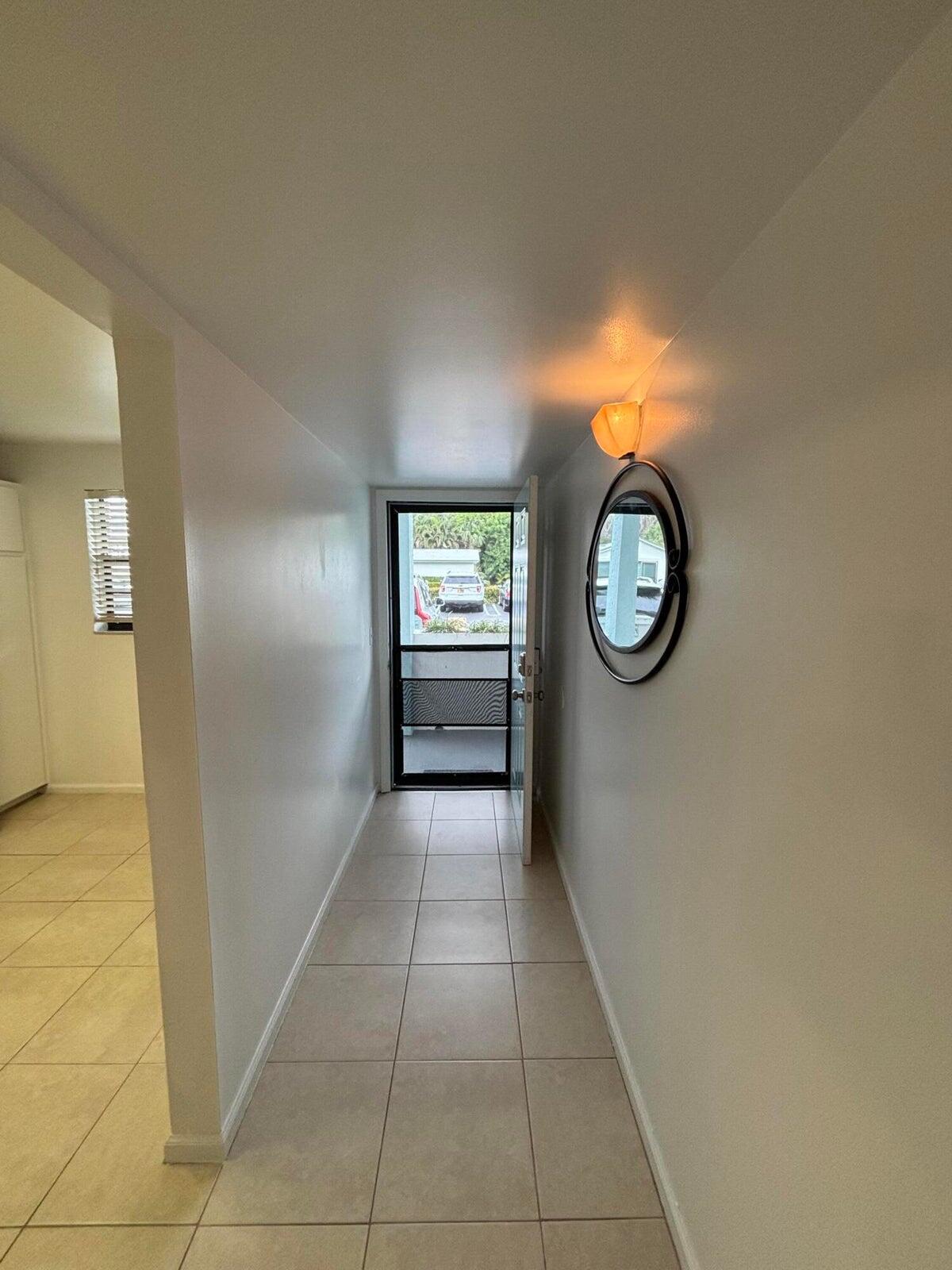 555 Banyan Tree Lane, Unit 109 Delray Beach, FL 33483 - Photo 4 of 17 a view of a hallway with windows