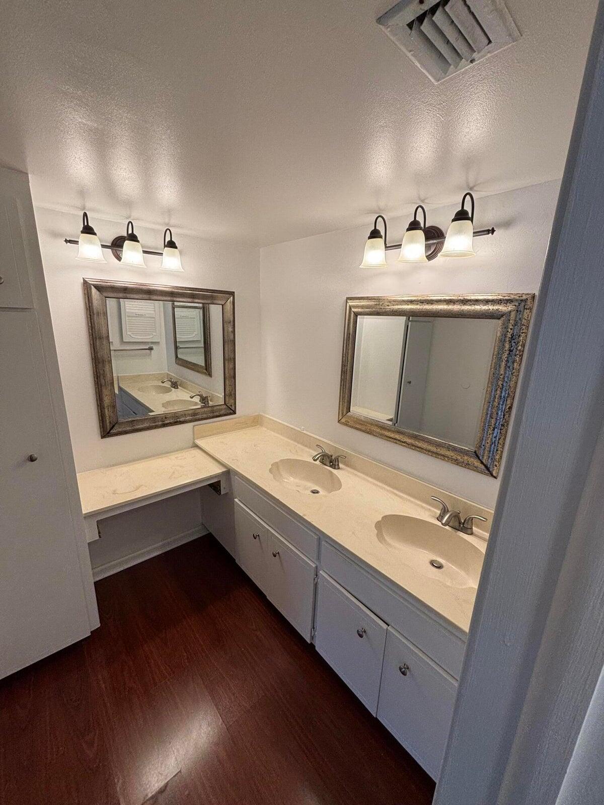555 Banyan Tree Lane, Unit 109 Delray Beach, FL 33483 - Photo 8 of 17 a bathroom with a sink and a mirror