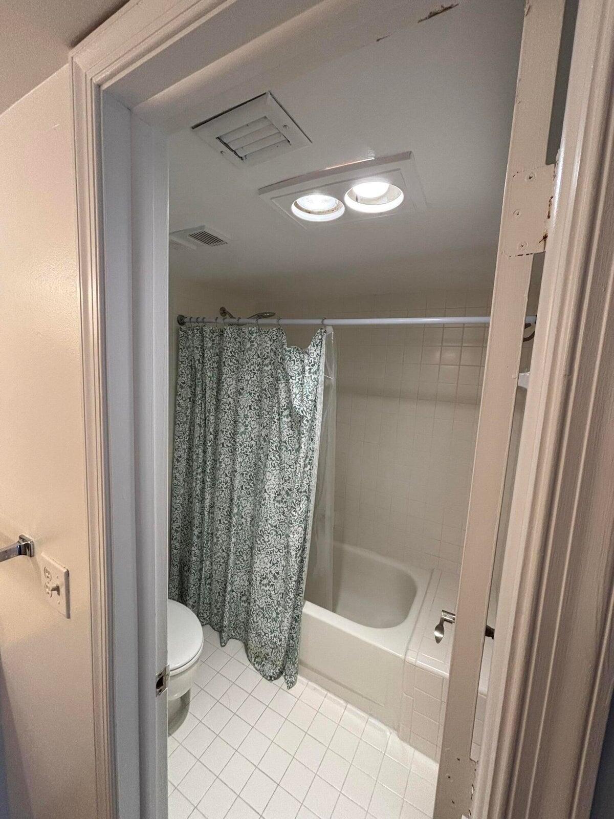 555 Banyan Tree Lane, Unit 109 Delray Beach, FL 33483 - Photo 9 of 17 a bathroom with a toilet and a shower