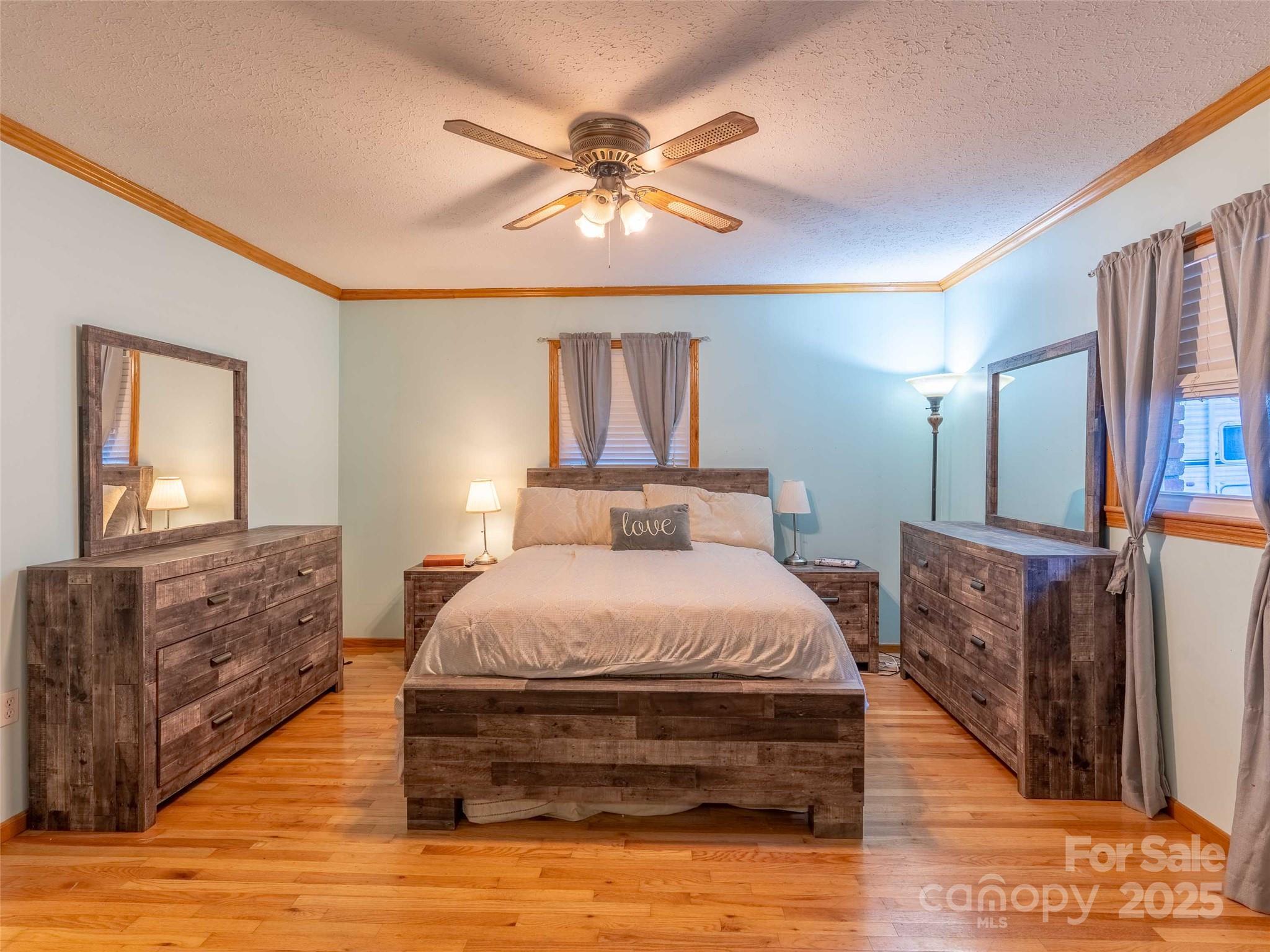 1000 Mountain View Church Road Zirconia, NC 28790 - Photo 18 of 22 a bedroom with a bed lamps and wooden floor