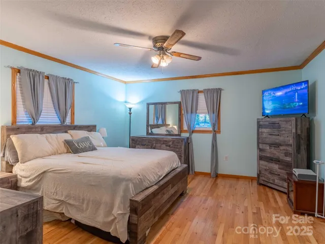 a bedroom with a bed and a ceiling fan