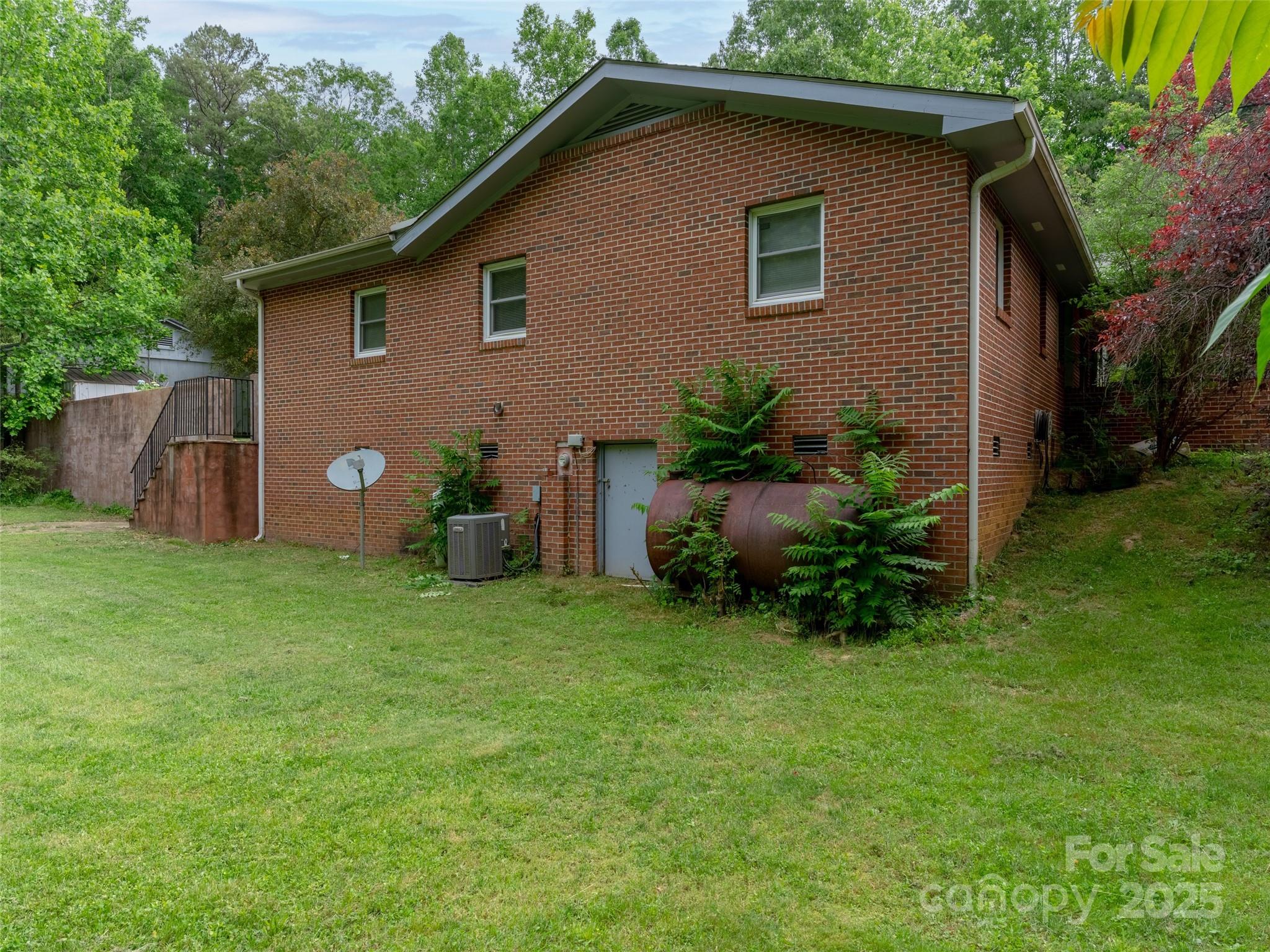 1000 Mountain View Church Road Zirconia, NC 28790 - Photo 21 of 22 a view of a house with a yard and plants