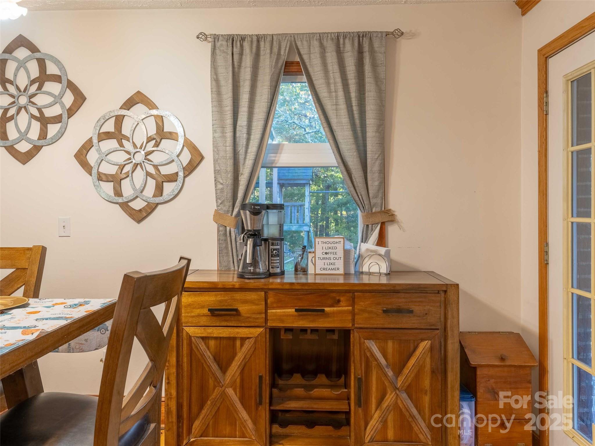 1000 Mountain View Church Road Zirconia, NC 28790 - Photo 8 of 22 a view of a dining room with furniture and window
