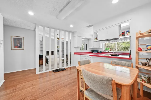 a kitchen with kitchen island stainless steel appliances a stove top oven and a refrigerator