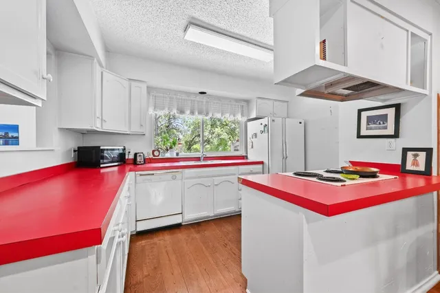 a kitchen with stainless steel appliances granite countertop a refrigerator and a stove