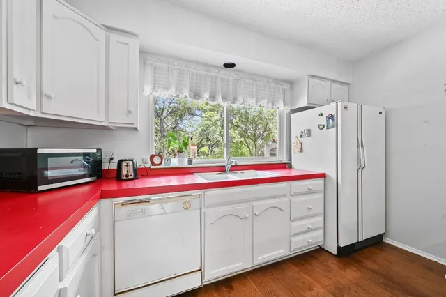 a kitchen with a stove a sink and a refrigerator