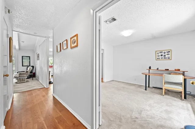a view of a hallway with wooden floor