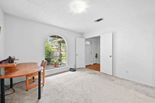 an empty room with windows and a fireplace