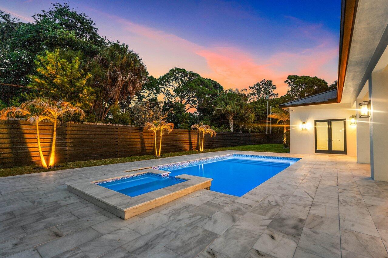 5701 Old Orange Road Jupiter, FL 33458 - Photo 16 of 46 a view of pool with lawn chairs and wooden fence