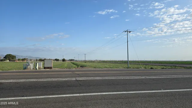 a view of a field of grass and trees