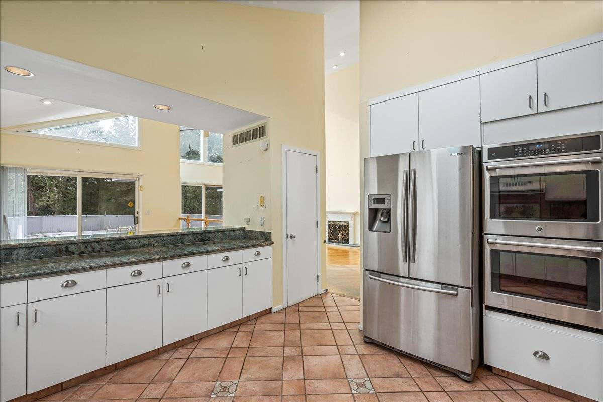 8 Fiddler Crab Trail Westhampton, NY 11977 - Photo 15 of 43 a kitchen with granite countertop a refrigerator and a sink