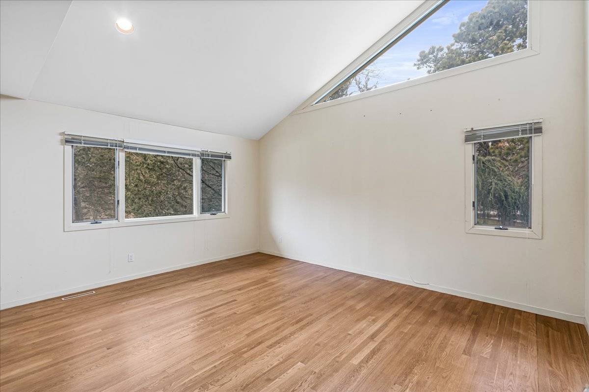 8 Fiddler Crab Trail Westhampton, NY 11977 - Photo 19 of 43 a view of an empty room with wooden floor and a window