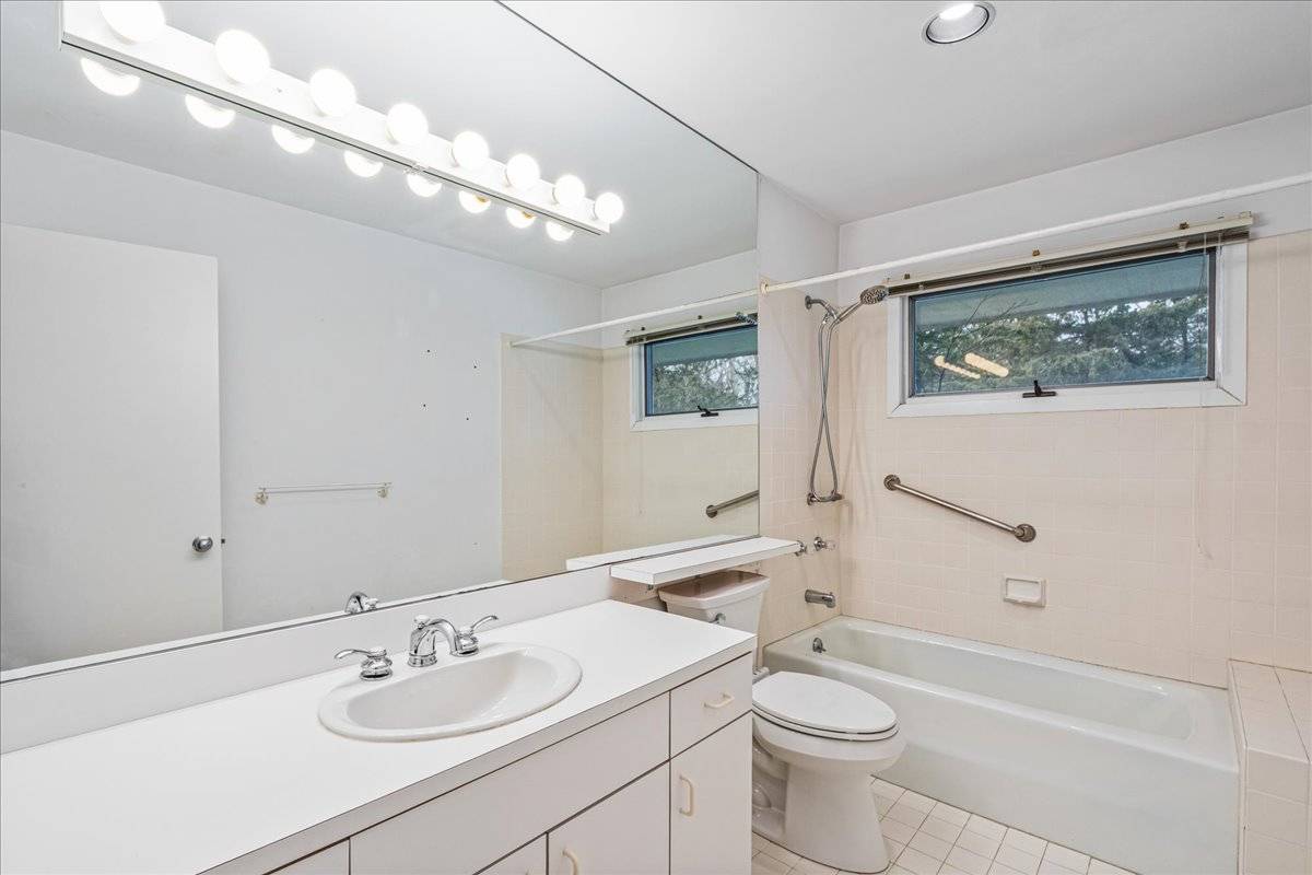 8 Fiddler Crab Trail Westhampton, NY 11977 - Photo 21 of 43 a bathroom with a sink a toilet and shower