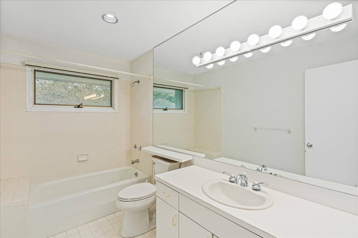8 Fiddler Crab Trail Westhampton, NY 11977 - Photo 24 of 43 a bathroom with a toilet a sink a mirror and a bathtub