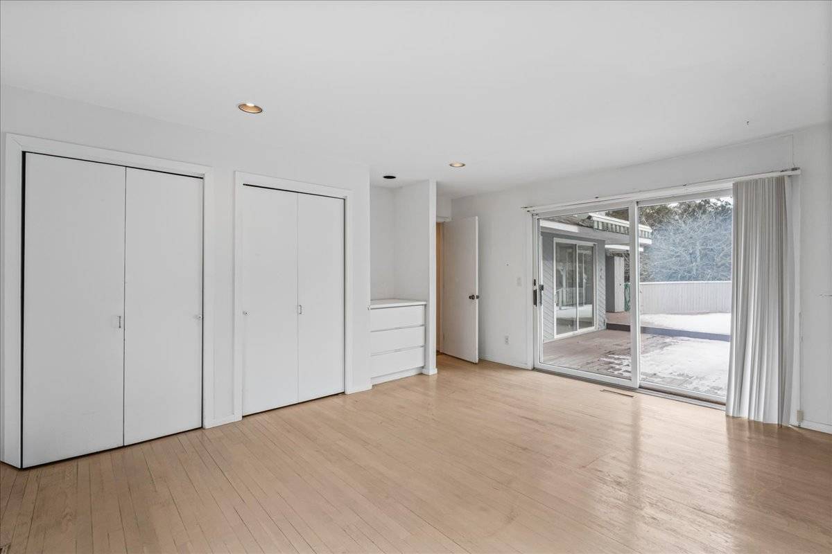 8 Fiddler Crab Trail Westhampton, NY 11977 - Photo 25 of 43 a view of an empty room with glass door