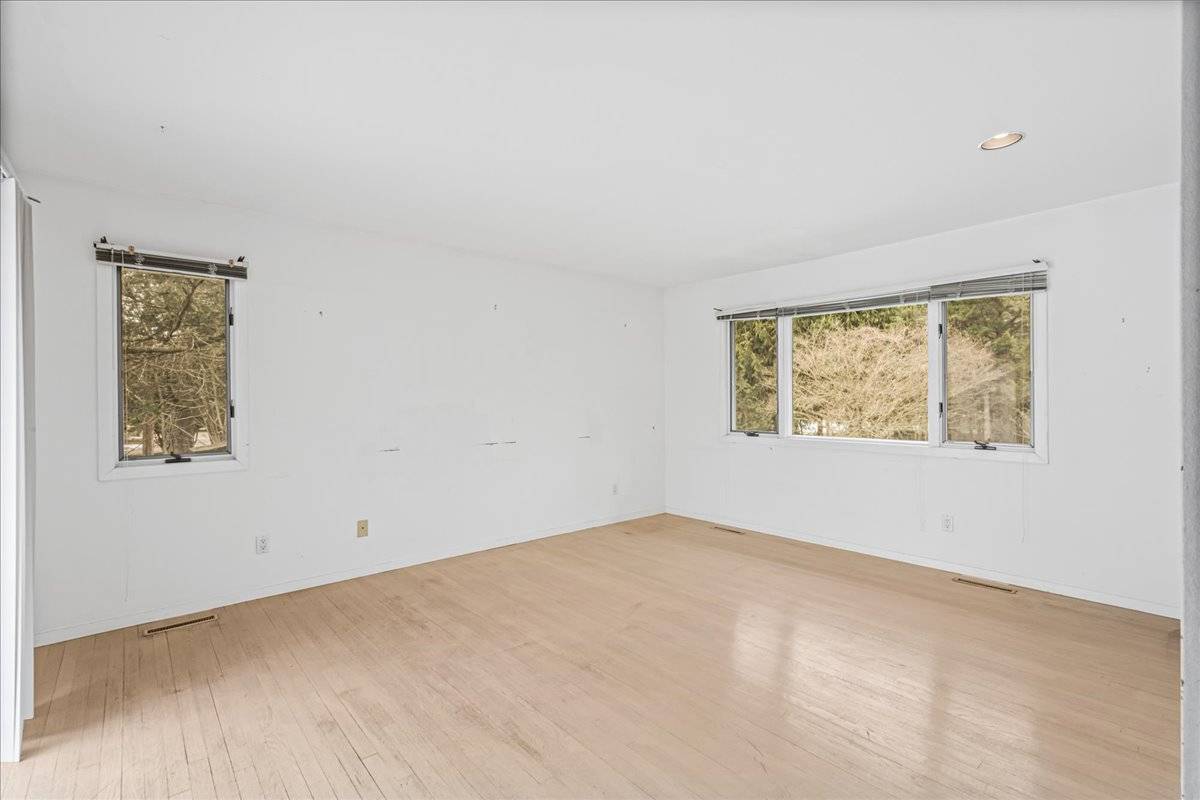 8 Fiddler Crab Trail Westhampton, NY 11977 - Photo 27 of 43 an empty room with windows