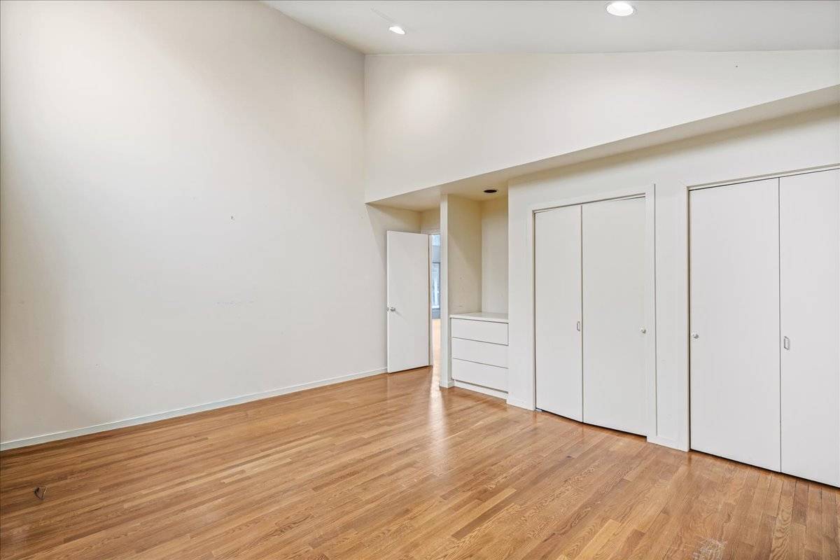 8 Fiddler Crab Trail Westhampton, NY 11977 - Photo 28 of 43 a view of an empty room with wooden floor