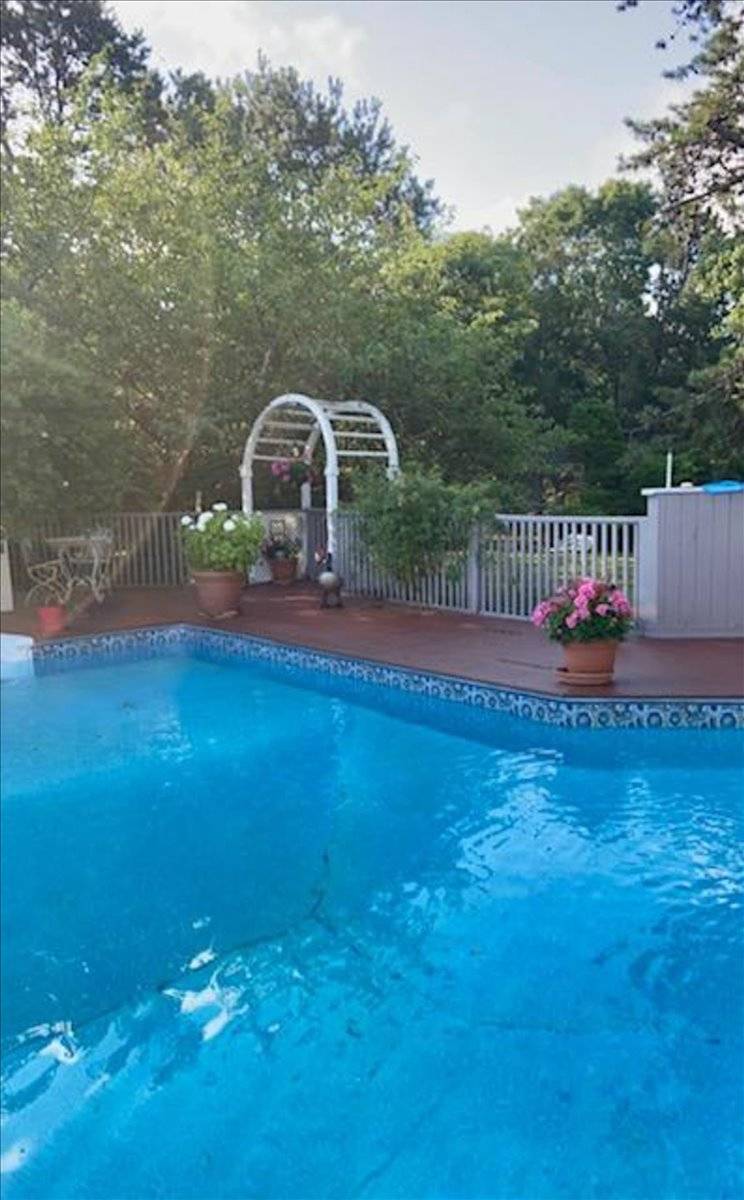 8 Fiddler Crab Trail Westhampton, NY 11977 - Photo 41 of 43 a terrace of a house with outdoor seating and lake view