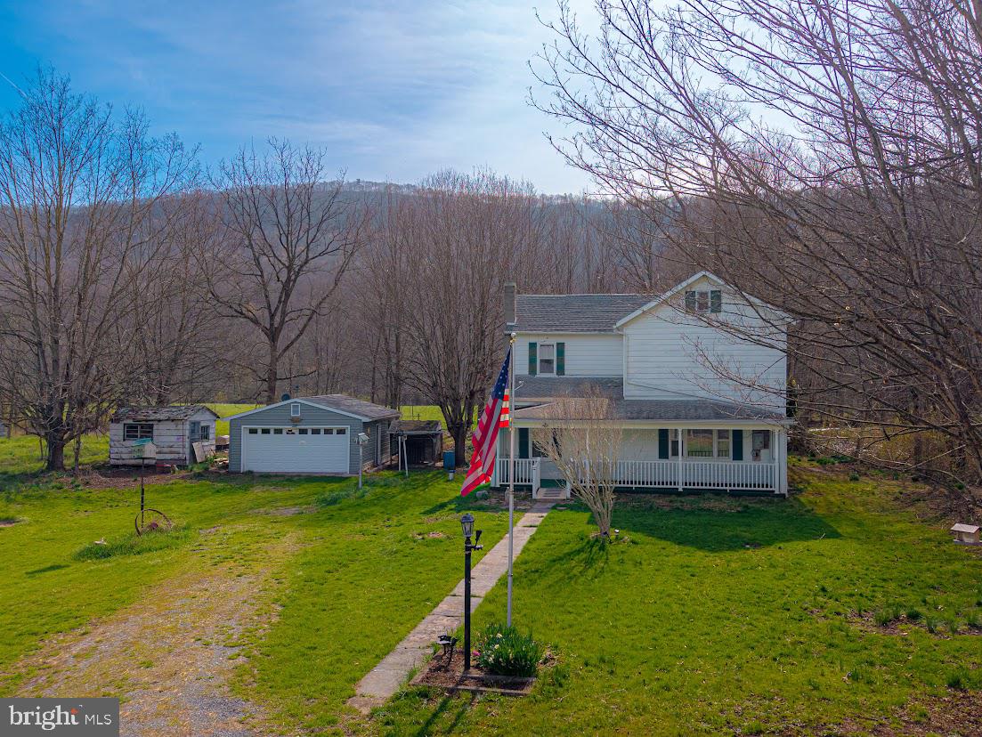 7016 Hyndman Road Buffalo Mills, PA 15534 - Photo 46 of 47 a view of a house with a yard porch and sitting area