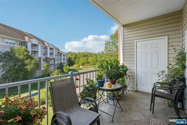 a view of a chairs and table in the balcony