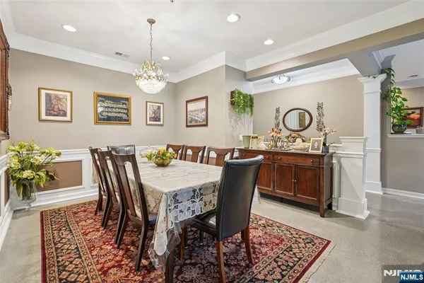 a view of a a dining room with furniture window and wooden floor