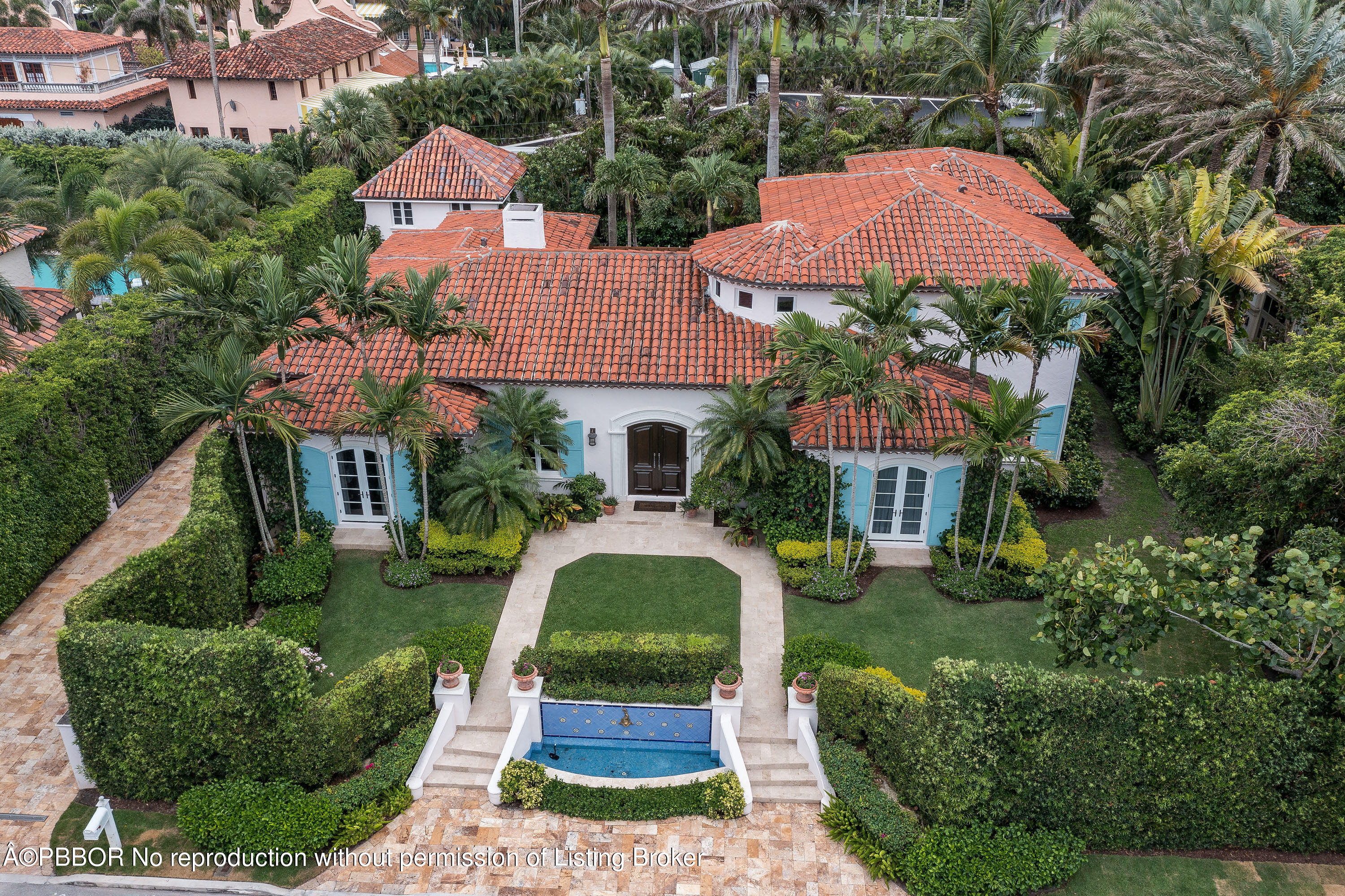 150 Woodbridge Road Palm Beach, FL 33480 - Photo 1 of 32 a front view of house with yard and green space