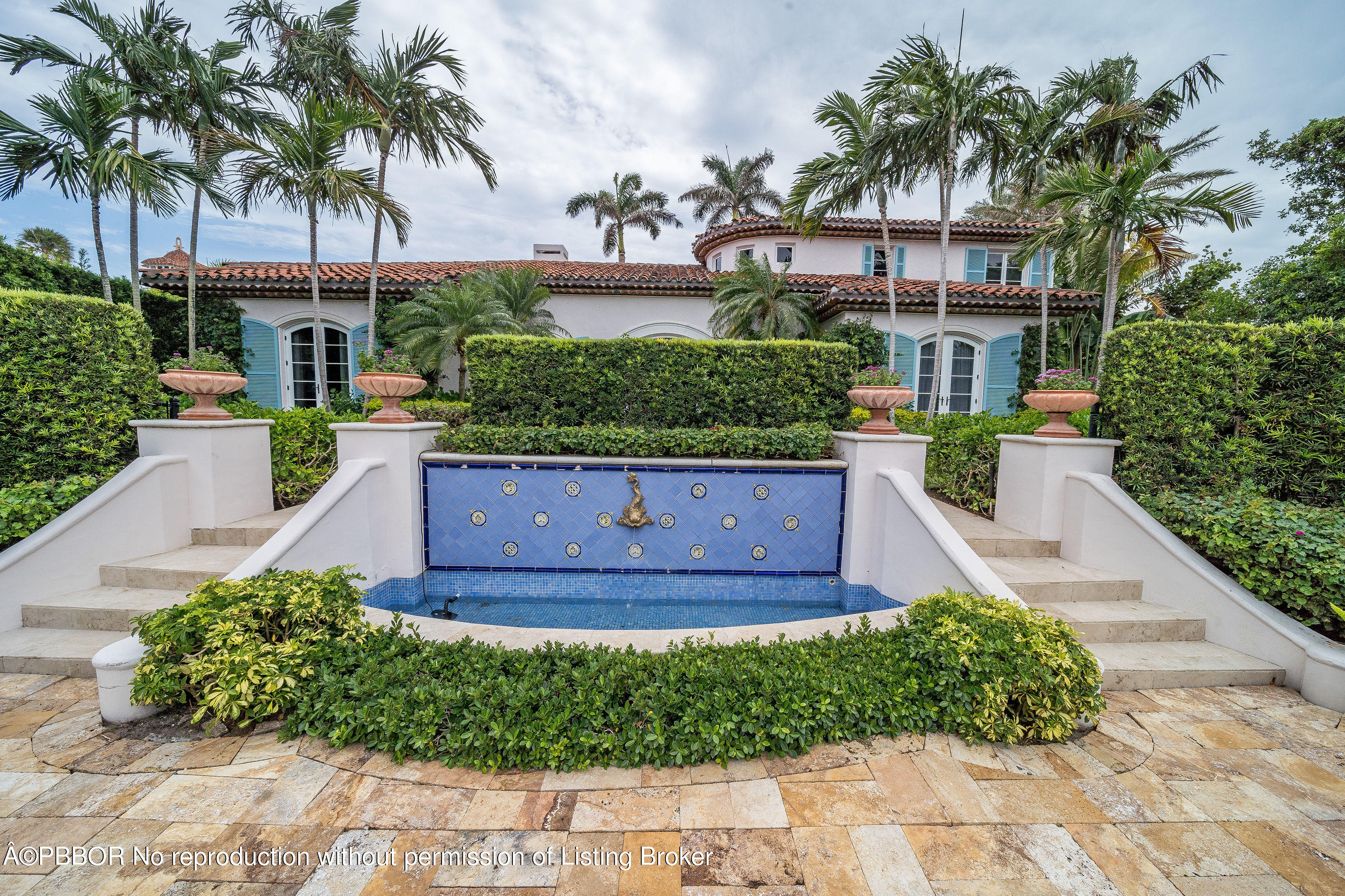 150 Woodbridge Road Palm Beach, FL 33480 - Photo 2 of 32 a front view of a house with a garden