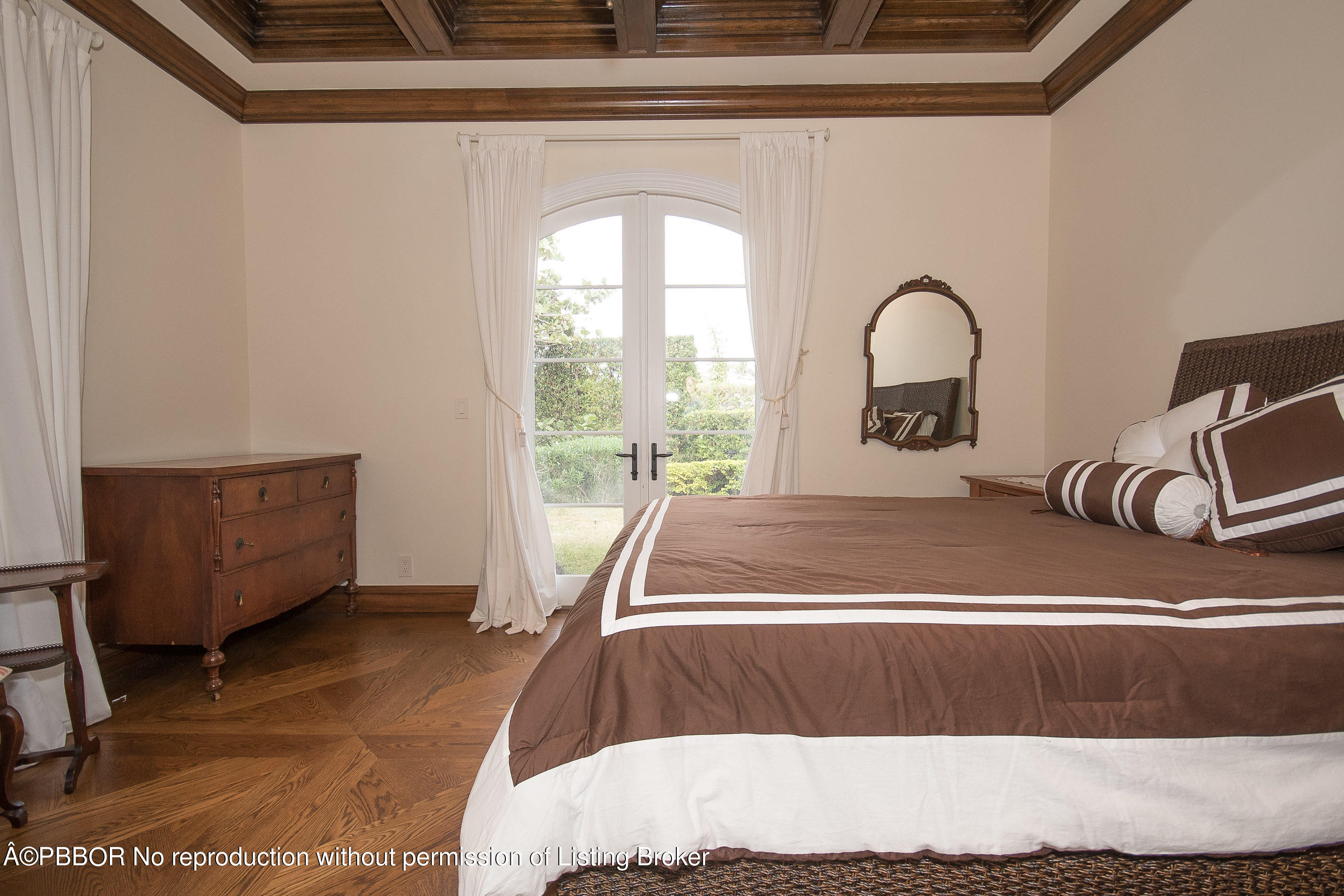 150 Woodbridge Road Palm Beach, FL 33480 - Photo 14 of 32 a bed sitting in a room next to a window