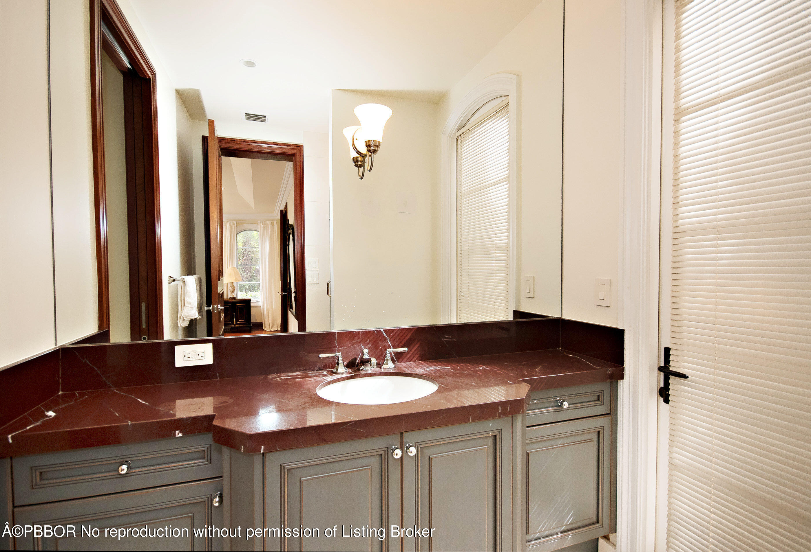 150 Woodbridge Road Palm Beach, FL 33480 - Photo 15 of 32 a bathroom with a sink and a mirror