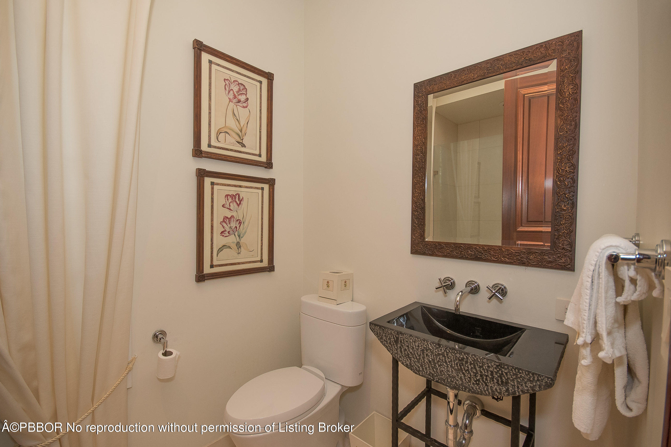 150 Woodbridge Road Palm Beach, FL 33480 - Photo 17 of 32 a bathroom with a granite countertop sink toilet a mirror and vanity