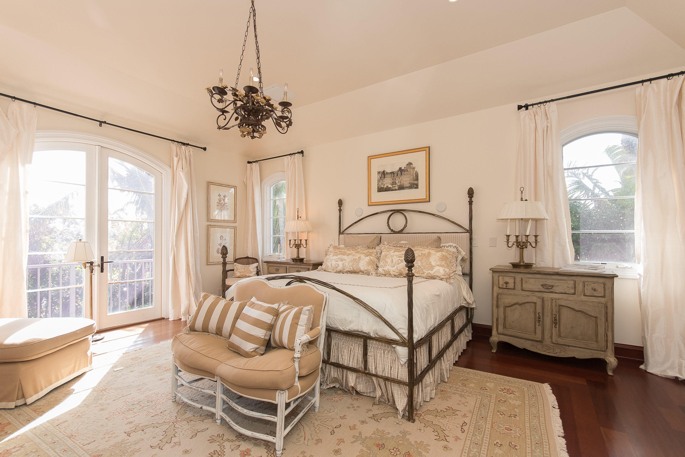 150 Woodbridge Road Palm Beach, FL 33480 - Photo 18 of 32 a bedroom with a bed and a chandelier