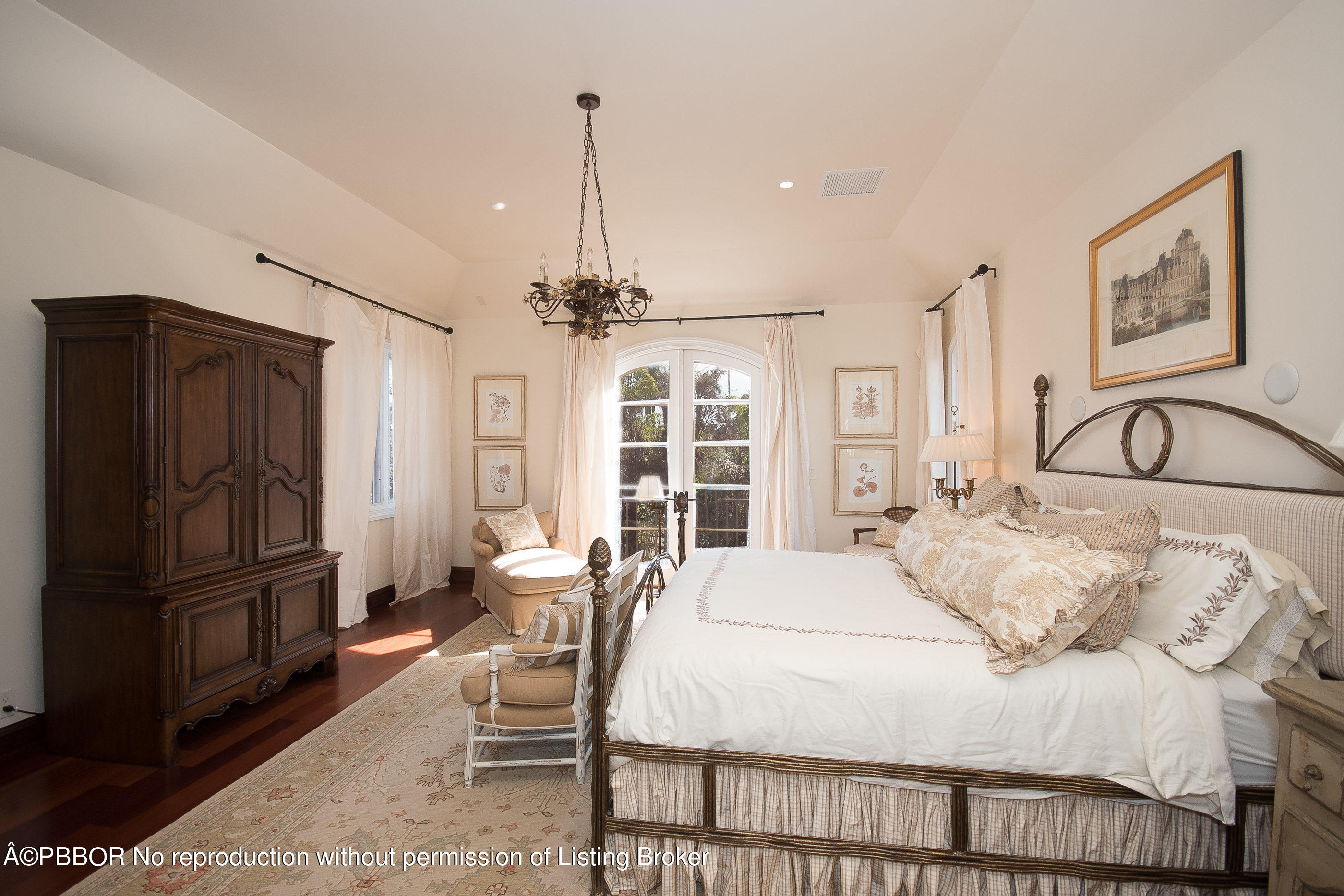 150 Woodbridge Road Palm Beach, FL 33480 - Photo 19 of 32 a bedroom with a bed a table and chair