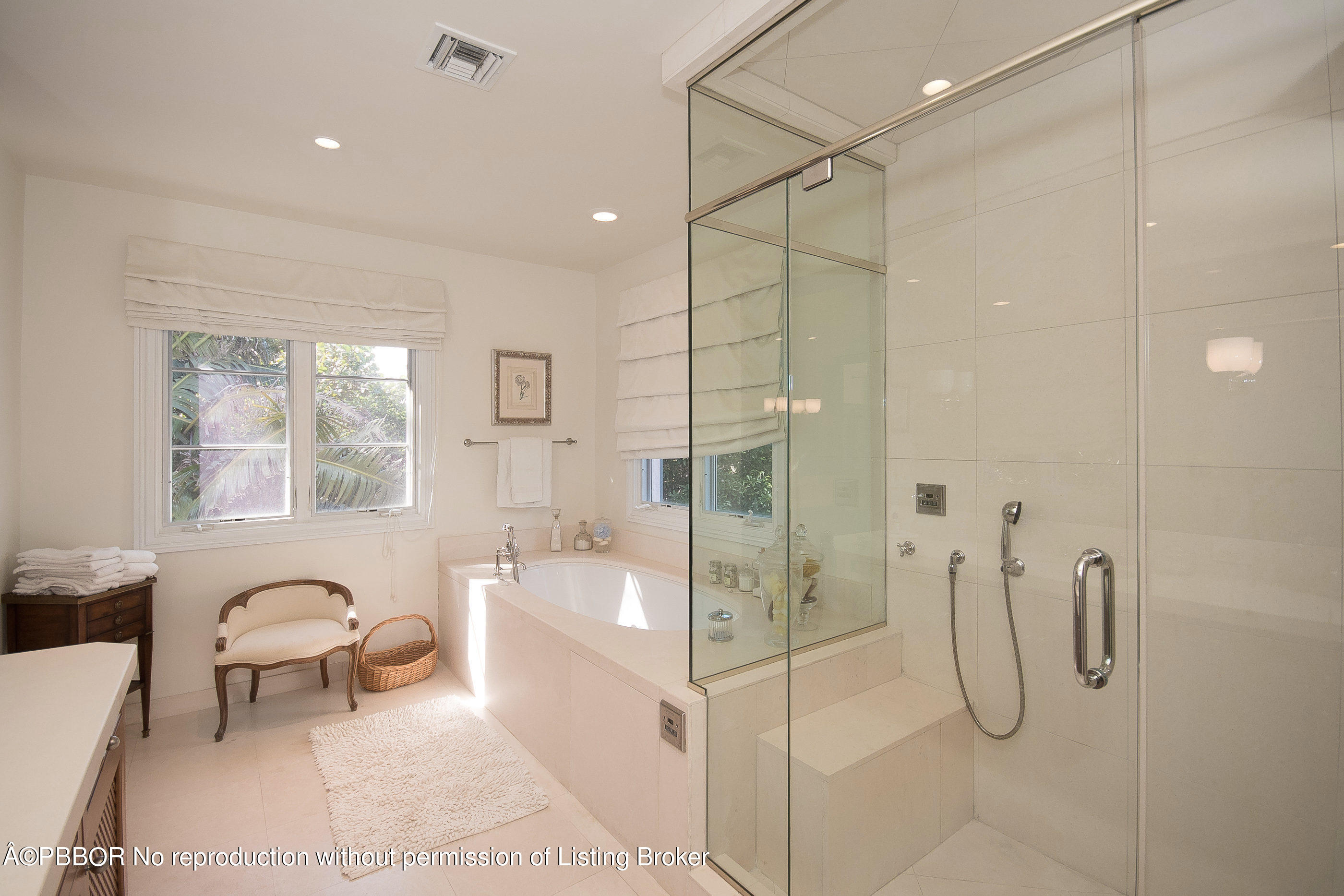 150 Woodbridge Road Palm Beach, FL 33480 - Photo 21 of 32 a bathroom with a tub shower a mirror and a sink