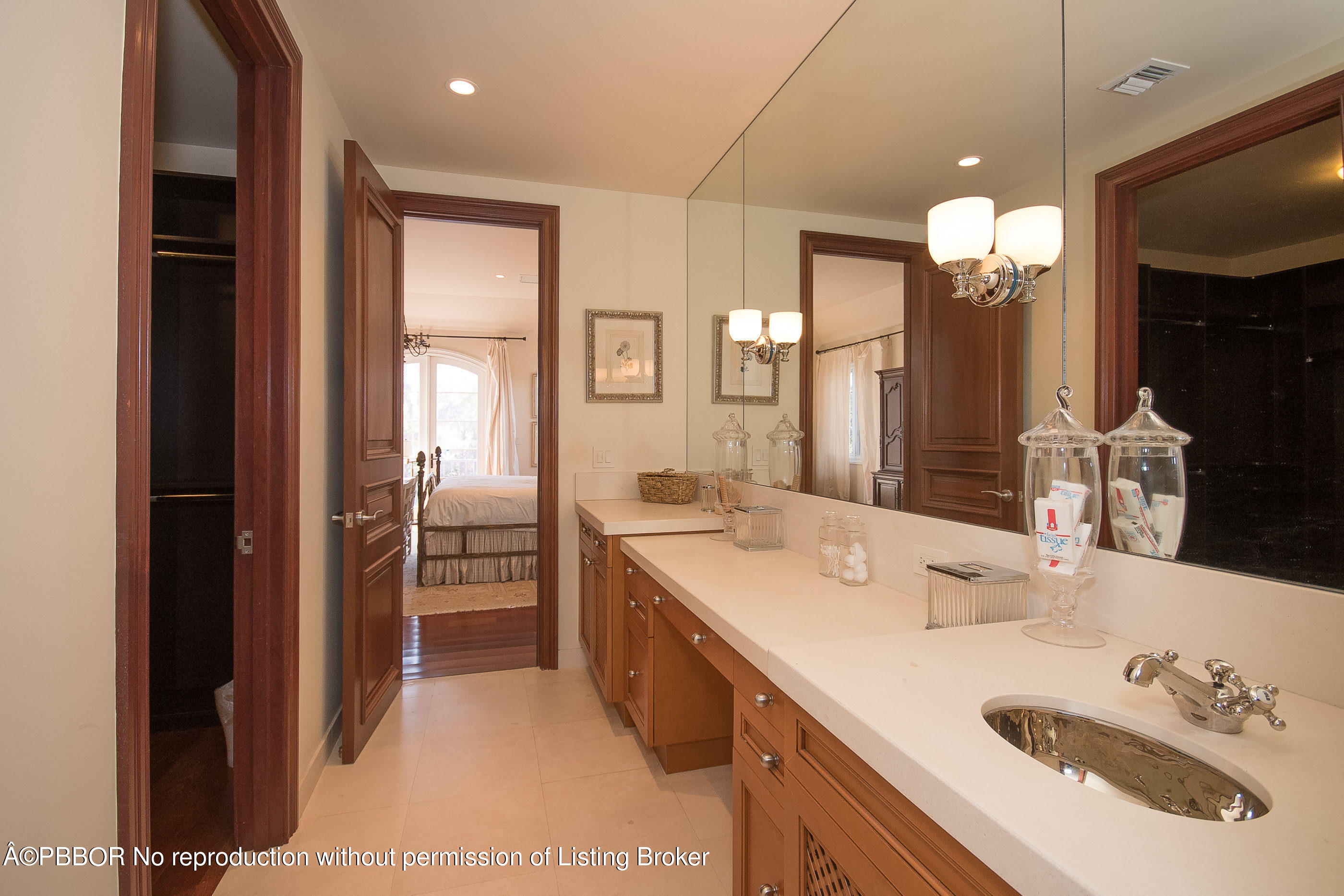 150 Woodbridge Road Palm Beach, FL 33480 - Photo 22 of 32 a bathroom with a sink double vanity and a mirror