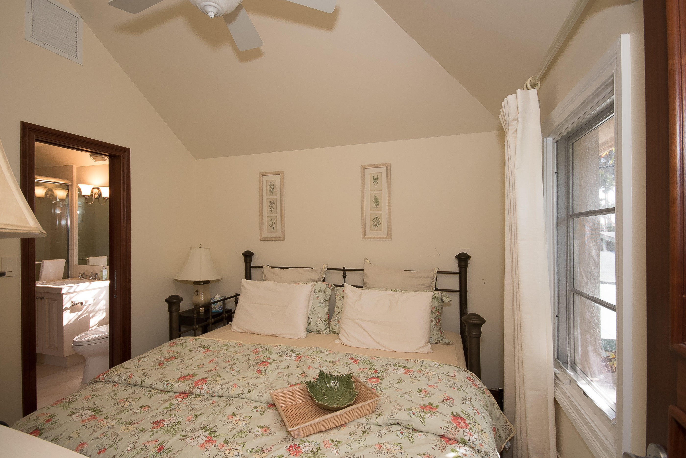 150 Woodbridge Road Palm Beach, FL 33480 - Photo 25 of 32 a bedroom with a bed and wooden floor